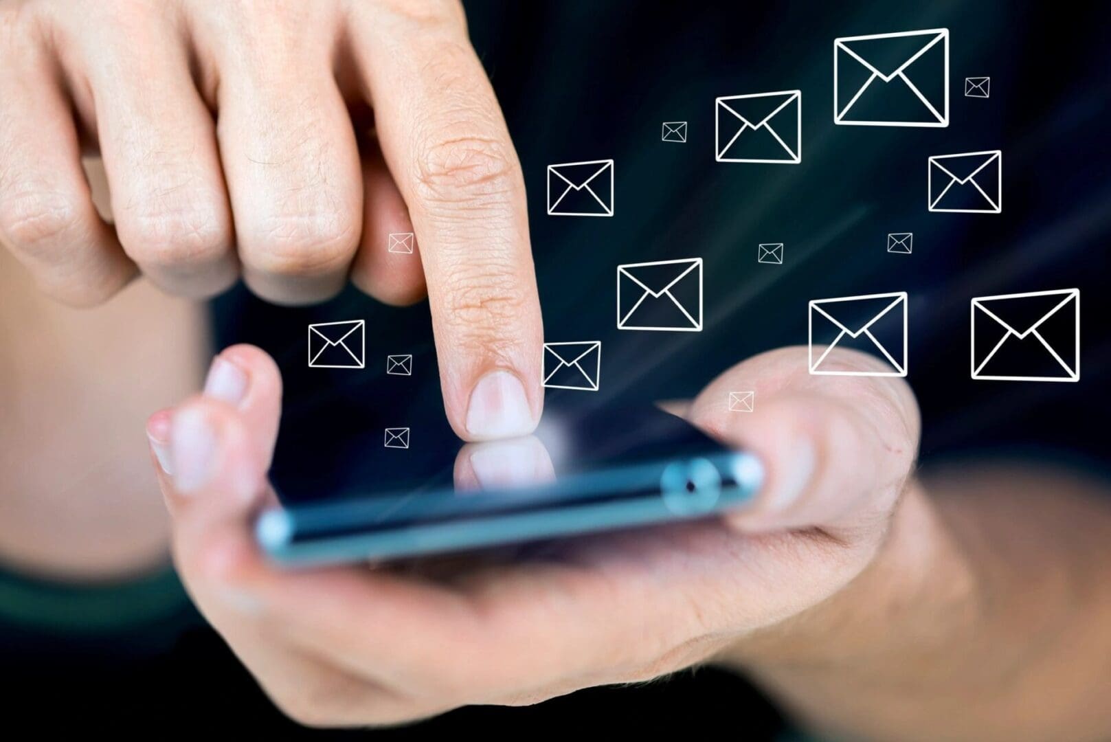 A person is using their phone with email icons above them.